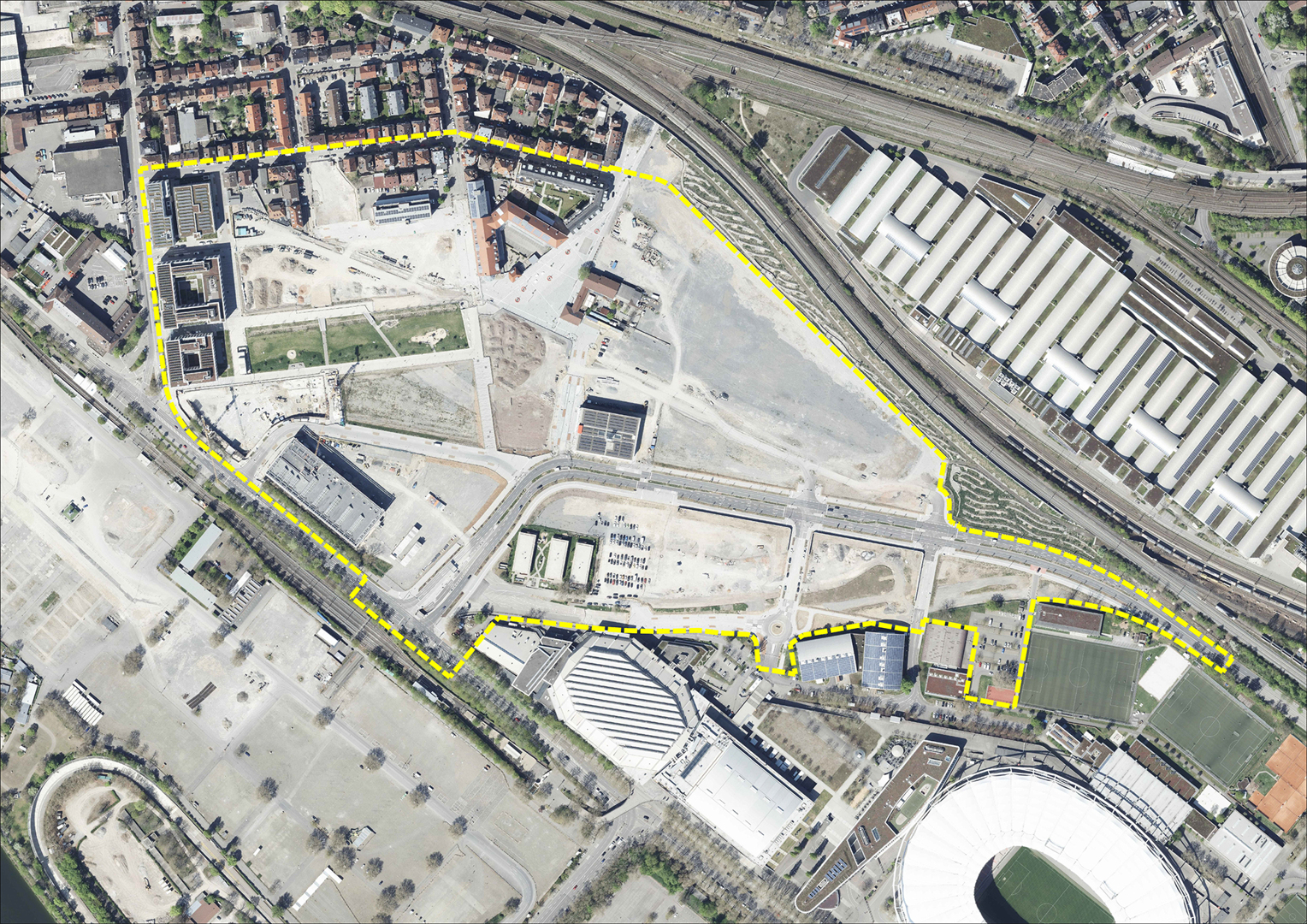Das Luftbild zeigt die Draufsicht auf das Areal Neckarpark. Die zum Quartier gehörende Fläche ist mit einer gelb-gestrichelten Linie umrandet.
